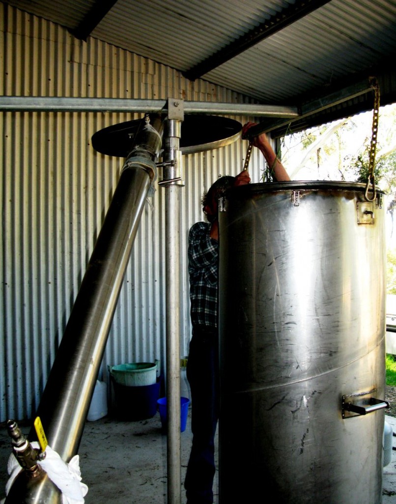 The distillation chamber is manually swung onto the still base using a fulcrum.  This takes a lot of strength.   Once in position the lid with the condenser are clamped into place ready for distillation to begin.
